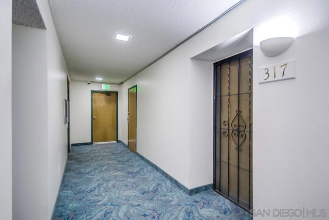 corridor with a textured ceiling