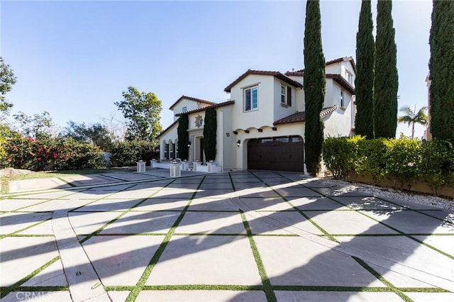 mediterranean / spanish home with a garage