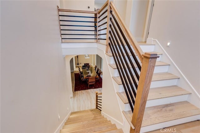 staircase featuring wood-type flooring