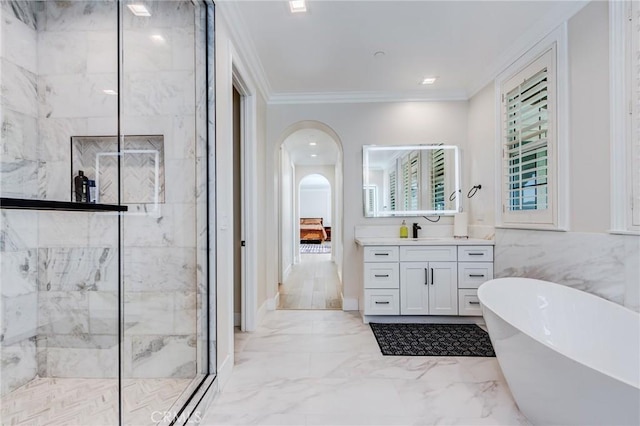 bathroom featuring independent shower and bath, tile walls, crown molding, and vanity