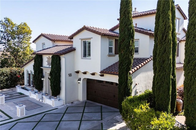 mediterranean / spanish home featuring a garage