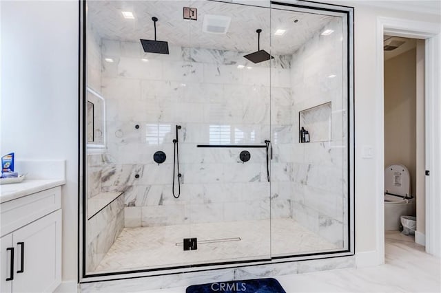 bathroom with a shower with door and vanity