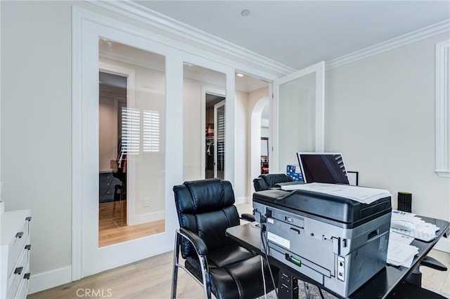 office area featuring light hardwood / wood-style floors and crown molding