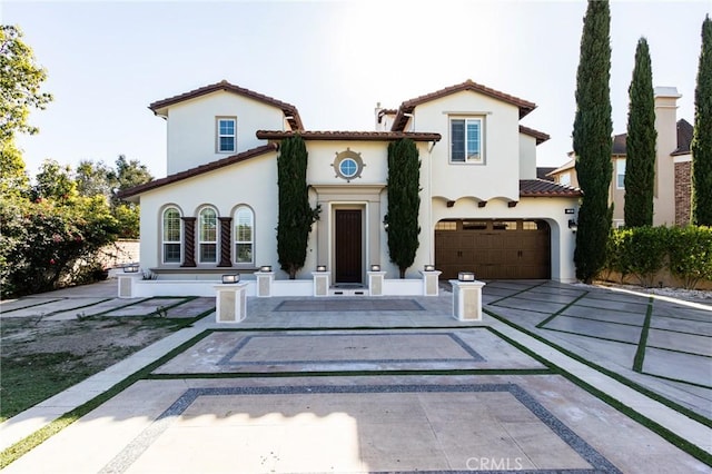 mediterranean / spanish home featuring a garage