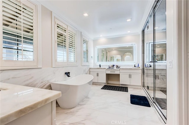 bathroom with independent shower and bath, ornamental molding, and vanity