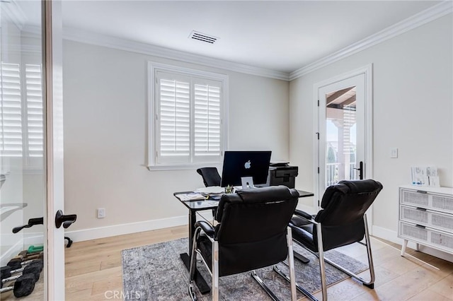 office area with light wood-type flooring and ornamental molding