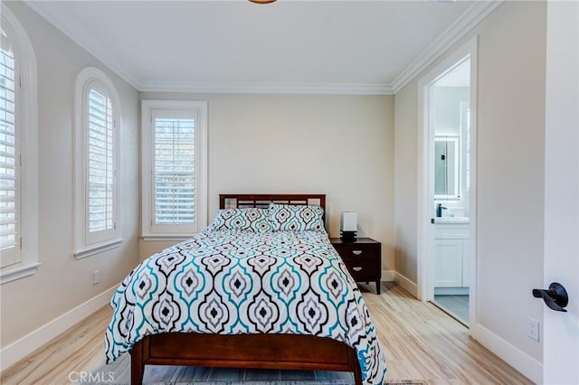 bedroom featuring ensuite bathroom, crown molding, and light hardwood / wood-style flooring