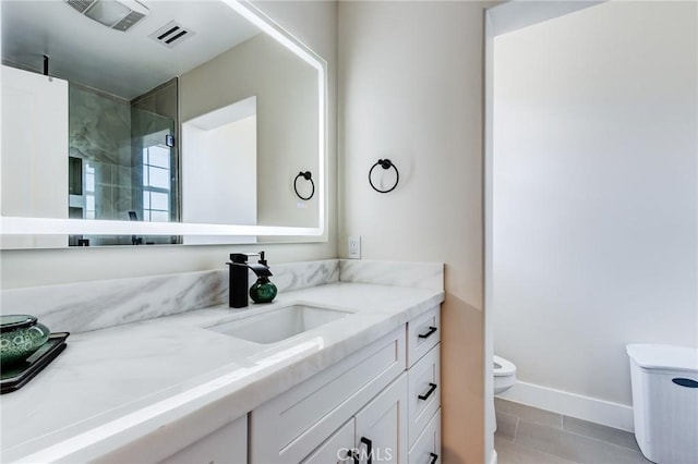 bathroom featuring toilet, tile patterned floors, and vanity