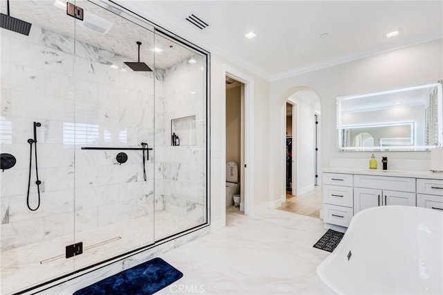 full bathroom featuring toilet, ornamental molding, independent shower and bath, and vanity