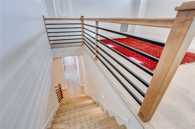 stairs featuring hardwood / wood-style floors