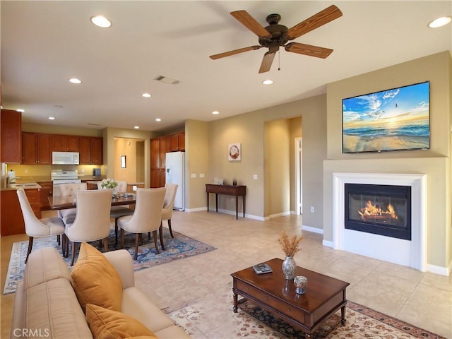 living room featuring ceiling fan and light tile patterned floors