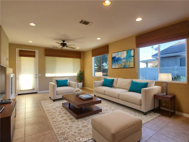 tiled living room with ceiling fan