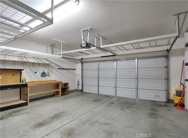 garage featuring a garage door opener and a workshop area