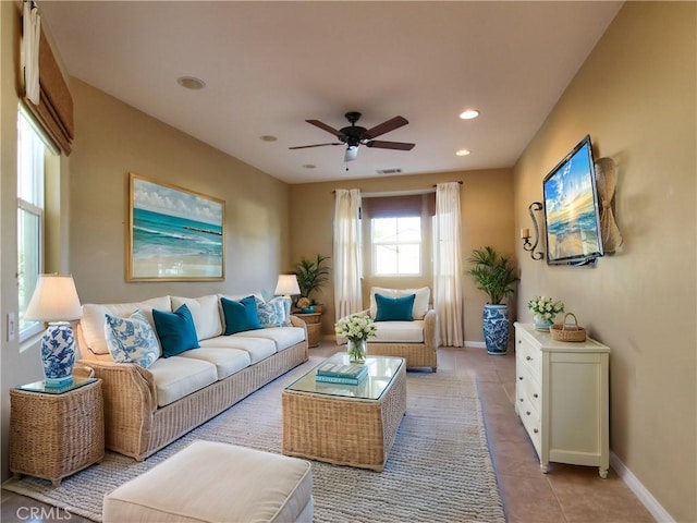 living room featuring ceiling fan and light tile patterned flooring