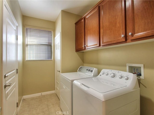 washroom with cabinets and separate washer and dryer