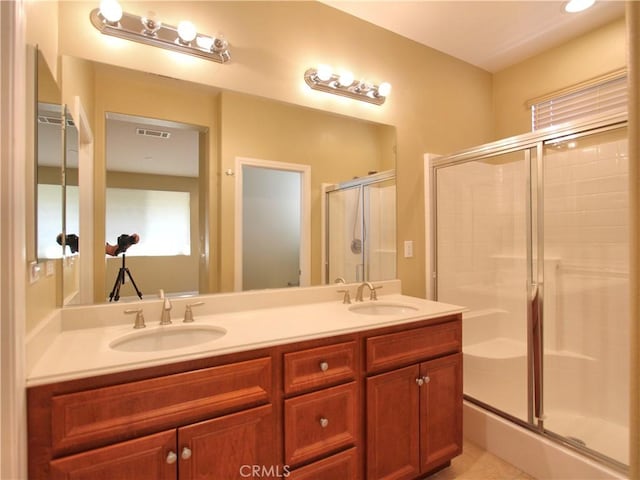 bathroom featuring vanity, tile patterned flooring, and a shower with door