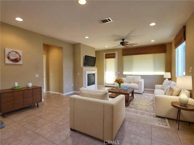 living room with ceiling fan and light tile patterned floors