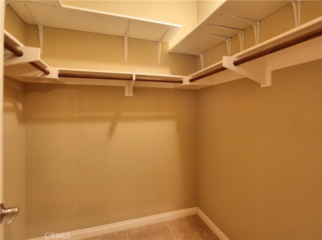 walk in closet with tile patterned floors