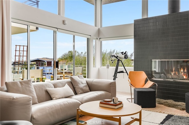 sunroom / solarium with a fireplace