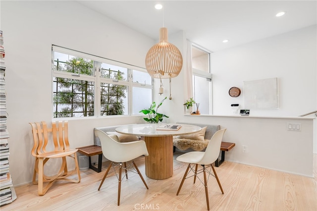 dining space with light wood-type flooring and breakfast area