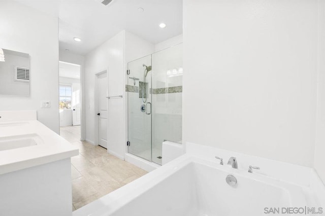 bathroom with tile patterned flooring, vanity, and plus walk in shower