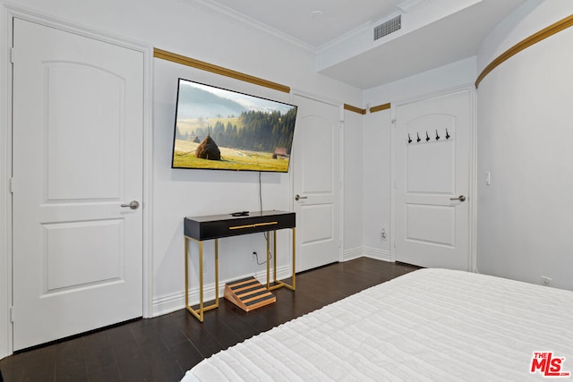 bedroom featuring dark hardwood / wood-style flooring and crown molding