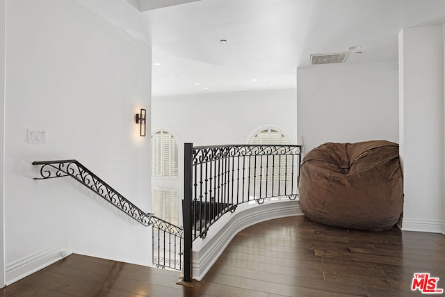 stairs featuring wood-type flooring