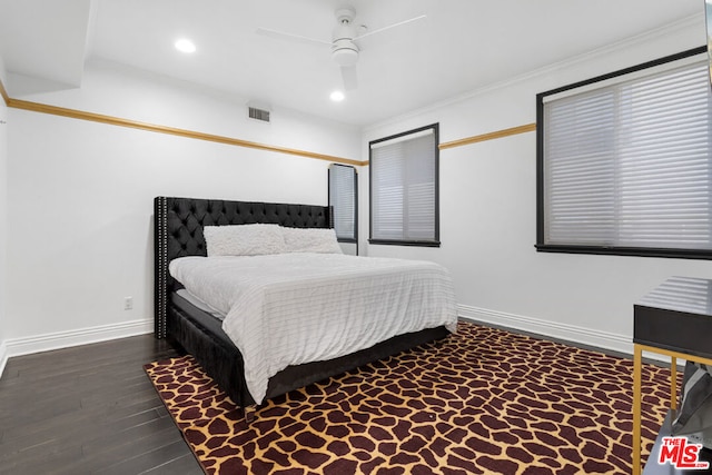 bedroom featuring ceiling fan, dark hardwood / wood-style flooring, and crown molding