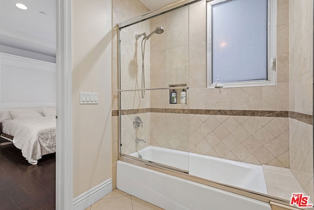 bathroom with enclosed tub / shower combo, tile patterned floors, and crown molding