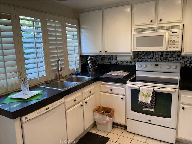 kitchen with backsplash, sink, white appliances, light tile patterned flooring, and white cabinets