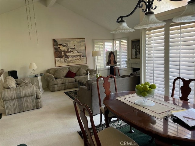 dining space with light carpet and lofted ceiling with beams