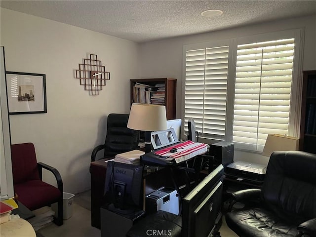 office area with a textured ceiling