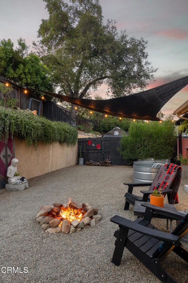 patio terrace at dusk with a fire pit