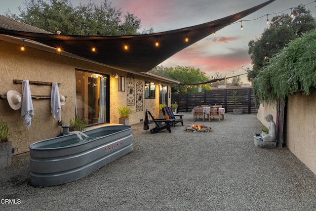 view of patio terrace at dusk