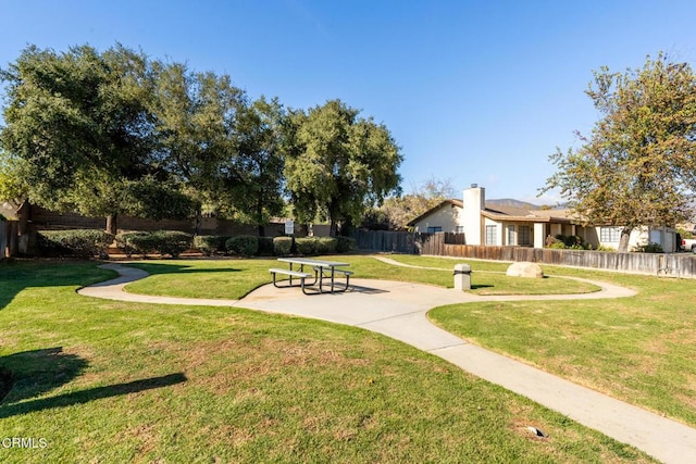 view of community with a yard and a patio