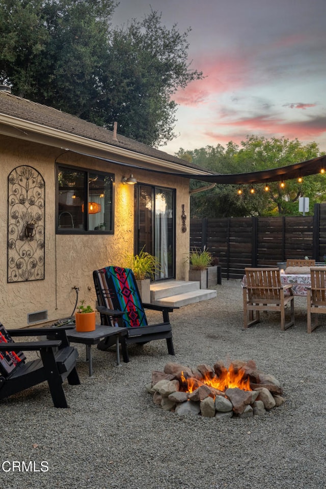 patio terrace at dusk with an outdoor fire pit