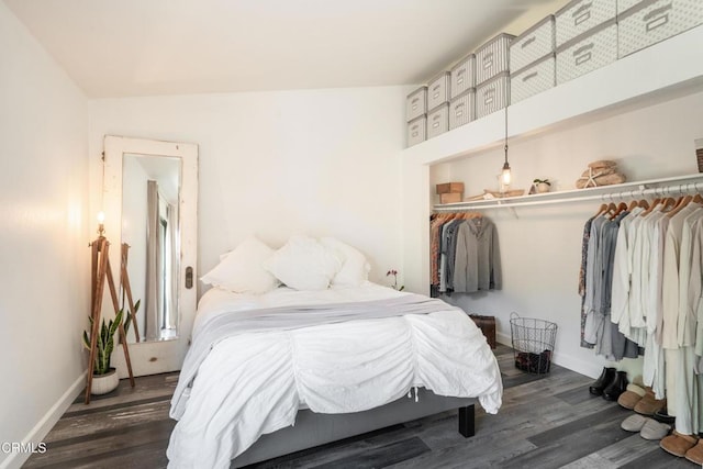 bedroom with baseboards, a closet, and wood finished floors
