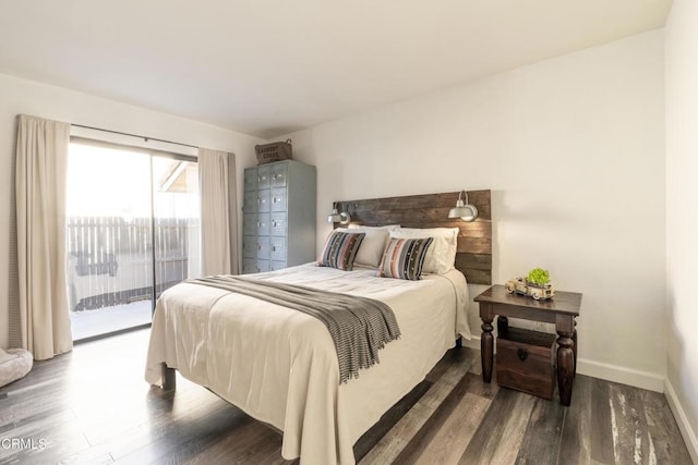 bedroom with baseboards, access to exterior, and wood finished floors