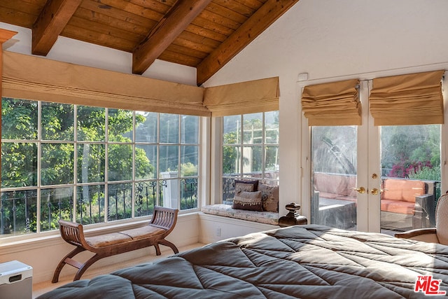 bedroom with lofted ceiling with beams, access to exterior, multiple windows, and wooden ceiling