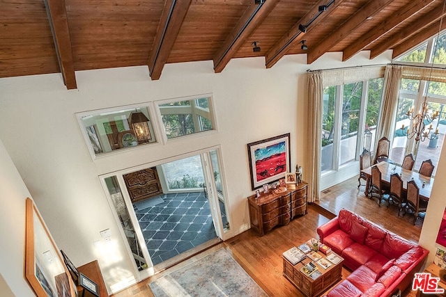 living room with wooden ceiling, hardwood / wood-style floors, and vaulted ceiling with beams