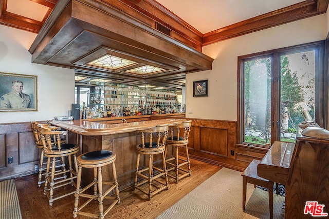 bar with crown molding and hardwood / wood-style floors