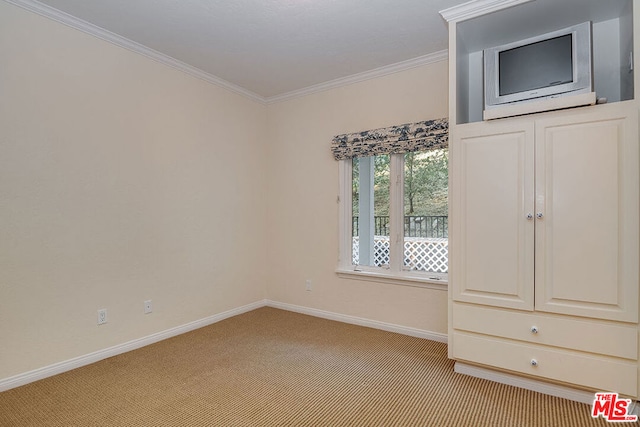 carpeted empty room with crown molding