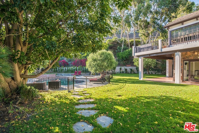 view of yard with a patio and a fenced in pool