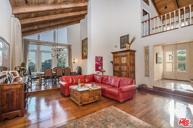 living room with wooden ceiling, a notable chandelier, wood-type flooring, high vaulted ceiling, and beamed ceiling