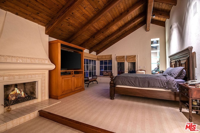 bedroom featuring wood ceiling, carpet flooring, high vaulted ceiling, a tile fireplace, and beam ceiling