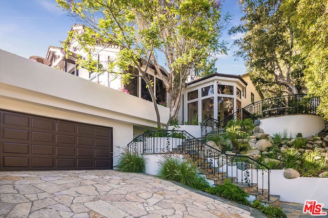 view of side of home featuring a garage