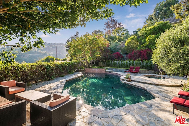 view of swimming pool featuring a patio