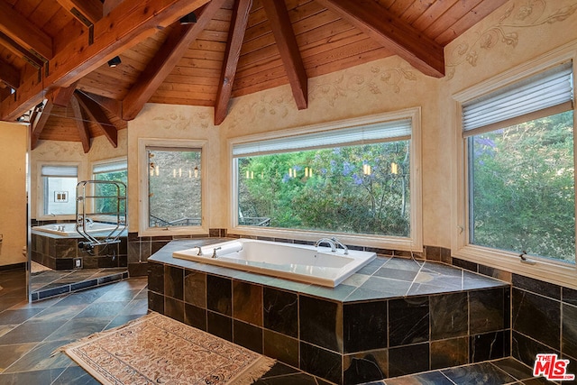 bathroom featuring a healthy amount of sunlight, wood ceiling, beamed ceiling, and a relaxing tiled tub