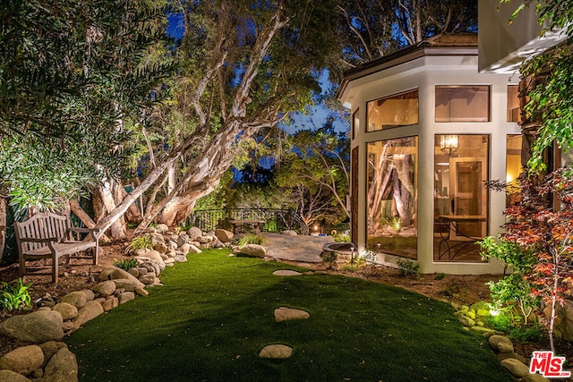 view of yard featuring a sunroom