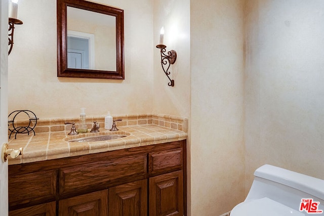 bathroom featuring toilet and vanity